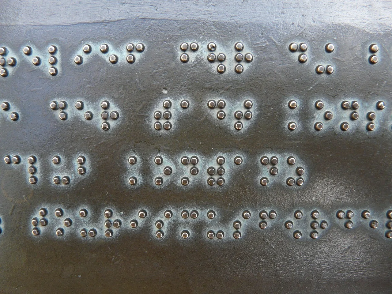 braille, writing, keys, metal plate, bronze, palpable, visually impaired, barrier-free, accessibility, braille, braille, braille, braille, braille. AODA web design Ontario compliance for agencies