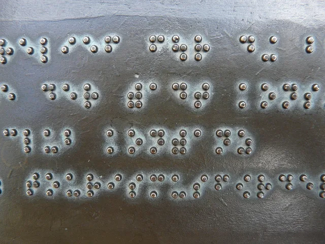 braille, writing, keys, metal plate, bronze, palpable, visually impaired, barrier-free, accessibility, braille, braille, braille, braille, braille. AODA web design Ontario compliance for agencies
