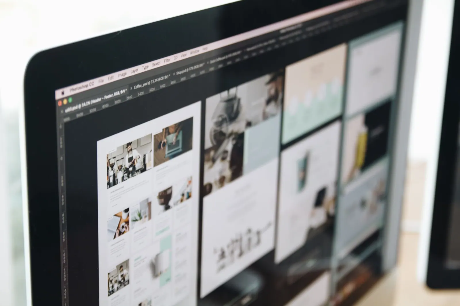 A modern computer screen displaying web design work, showcasing creative visuals in a workspace. Web design agency services and packages guide for 2027