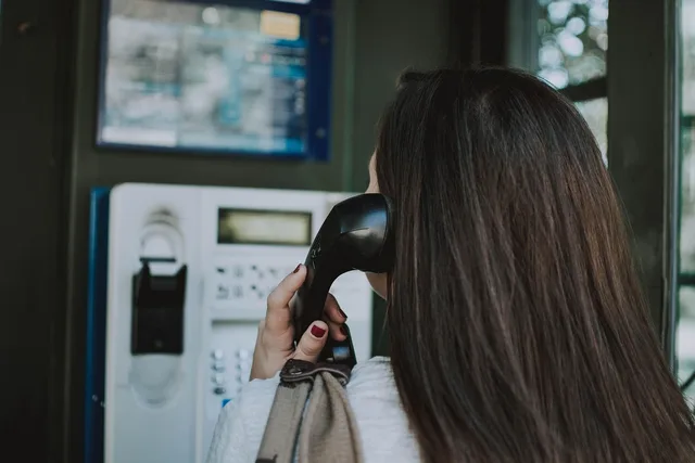 phone booth, woman, make a phone call, phone, call. When a design client churns, a fast and specific response wins them back